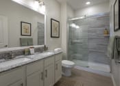 Thumbnail 18 of 21 - a bathroom with two sinks and a shower and a toilet