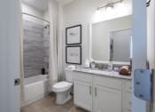 Thumbnail 16 of 21 - a bathroom with a shower toilet and sink and a mirror