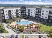 Thumbnail 1 of 21 - Two-Bedroom Apartments in Chattanooga, TN - Populus Waterside - Aerial View of Resort-Style Pool with Sun Shelf and Tanning Ledge, Lounge Seats, Pergola, Tables, Chairs, and Umbrellas.
