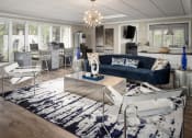 Thumbnail 3 of 31 - a living room with a blue couch and white chairs at Waterview at Rocky Point, Tampa, FL
