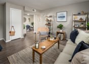 Thumbnail 16 of 31 - a living room with a couch coffee table and bookshelves at Waterview at Rocky Point, Tampa, FL