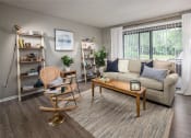 Thumbnail 13 of 31 - a living room with a couch and a chair in front of a sliding glass door  at Waterview at Rocky Point, Florida, 33634