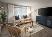 Thumbnail 14 of 31 - a living room with a couch coffee table and chairs and a tv on a blue dresser at Waterview at Rocky Point, Tampa, 33634