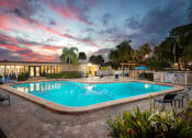 Thumbnail 1 of 31 - a resort style pool with lounge chairs and umbrellas at dusk  at Waterview at Rocky Point, Florida, 33634