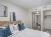 Thumbnail 12 of 36 - A bedroom with a large bed and a closet.