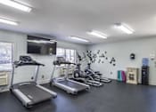 Thumbnail 4 of 36 - A spacious room with treadmills and elliptical machines.