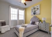 Thumbnail 12 of 14 - A bedroom with a bed, chair, and window.
