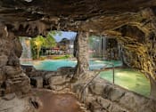 Thumbnail 18 of 32 - Columbus Luxury Apartments - Hot Tub In An Outdoor Indoor Man-Made Cave. Hot Tub Is Right Next To The Pool With A Waterfall.