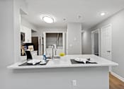 Thumbnail 5 of 13 - A kitchen with a white countertop and a sink.