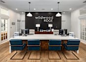 Thumbnail 14 of 30 - A conference room with a long table and chairs, and a sign that reads "Wildwood Ridge.".