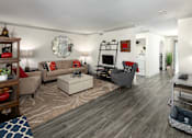 Thumbnail 6 of 30 - A living room with a grey couch and a white coffee table.
