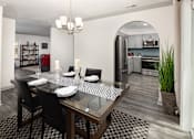 Thumbnail 4 of 30 - A modern dining room with a glass table and chairs.