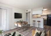 Thumbnail 5 of 28 - A modern living room with a dining table and chairs.
