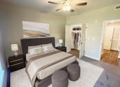 Thumbnail 14 of 31 - a bedroom with a large bed and a ceiling fan