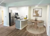 Thumbnail 5 of 31 - a kitchen and dining area with a stainless steel refrigerator