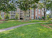 Thumbnail 26 of 26 - our apartments offer a spacious courtyard with green grass and trees