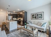 Thumbnail 5 of 26 - A modern kitchen with a white island and a bar stool.
