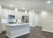 Thumbnail 12 of 50 - White kitchen at Icon Apartment Homes at Ferguson Farm, Bozeman, MT, 59718
