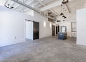 Thumbnail 14 of 33 - A large empty room with a concrete floor and white walls.