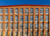 Thumbnail 28 of 33 - A red brick building with many windows.