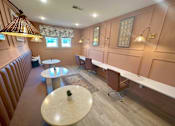 Thumbnail 6 of 23 - A room with brown walls and a white table in the middle.