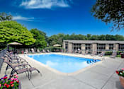 Thumbnail 2 of 26 - A pool surrounded by chairs and trees at Winchell Way Apartment , Kalamazoo, 49008