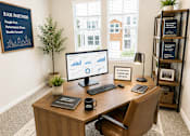 Thumbnail 33 of 71 - A room with a desk, chair, and computer monitor.