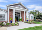 Thumbnail 1 of 36 - A building with a red brick facade and white trim.