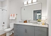 Thumbnail 20 of 48 - A bathroom with a white toilet and a white sink.