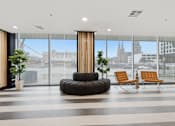 Thumbnail 24 of 40 - A modern waiting area with a view of the city.