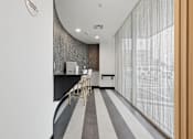 Thumbnail 40 of 40 - A white and black striped floor in a room with a white wall and a brown door.
