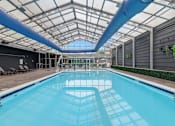 Thumbnail 13 of 40 - A large indoor swimming pool with a skylight above it.