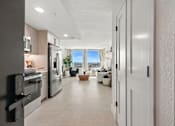 Thumbnail 3 of 40 - A modern kitchen with a view of the city.