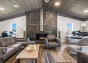 Thumbnail 20 of 29 - a living room with couches and chairs and a fireplace