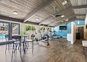 Thumbnail 16 of 29 - the residence on lamar apartment homes fitness room with exercise bike and table