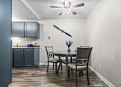Thumbnail 23 of 29 - a dining room with a table and chairs and a ceiling fan