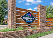 Thumbnail 18 of 18 - a sign for crosswinds villas in front of a wooden fence and brick
