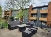 Thumbnail 17 of 27 - our apartments have a patio with chairs and a table at The Lodge Apartments, Tulsa, 74129