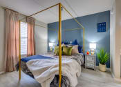 Thumbnail 10 of 27 - a bedroom with a gold canopy bed at The Lodge Apartments, Tulsa
