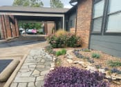 Thumbnail 3 of 27 - a garden of purple flowers in front of a building at The Lodge Apartments, Oklahoma, 74129