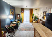 Thumbnail 7 of 27 - a living room with a couch and a table at The Lodge Apartments, Tulsa, OK 74129
