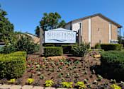 Thumbnail 3 of 22 - A sign for Reflections at Keefe is in front of a building.