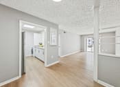 Thumbnail 7 of 17 - A kitchen with white appliances and wooden floors.