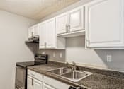Thumbnail 6 of 17 - A classic kitchen with white cabinets