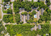 Thumbnail 15 of 17 - A bird's eye view of a residential area with houses, trees, and a swimming pool.