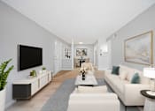 Thumbnail 11 of 17 - A modern living room with a white sofa, a grey rug, and a large painting on the wall.