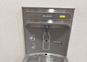 Thumbnail 17 of 40 - A gray water fountain with the word
