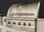 Thumbnail 14 of 40 - A stainless steel oven with a clock on the front and four burners below it.