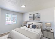 Thumbnail 5 of 35 - A bedroom with a large bed and a window overlooking a street.