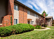 Thumbnail 17 of 35 - A red brick building with a green lawn in front.